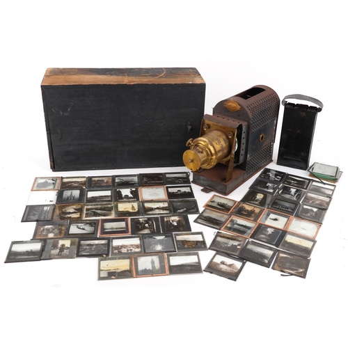 A vintage Optimus slide projector with brass lens, housed in a stained ...