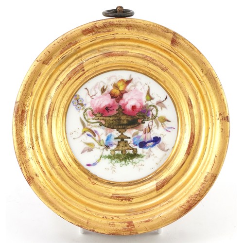 36 - Two 19th century porcelain plaques hand painted with flowers, each housed in a circular gilt frame, ... 