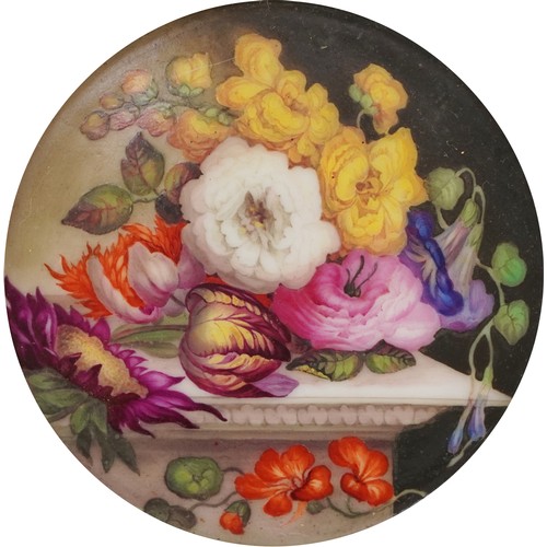 36 - Two 19th century porcelain plaques hand painted with flowers, each housed in a circular gilt frame, ... 