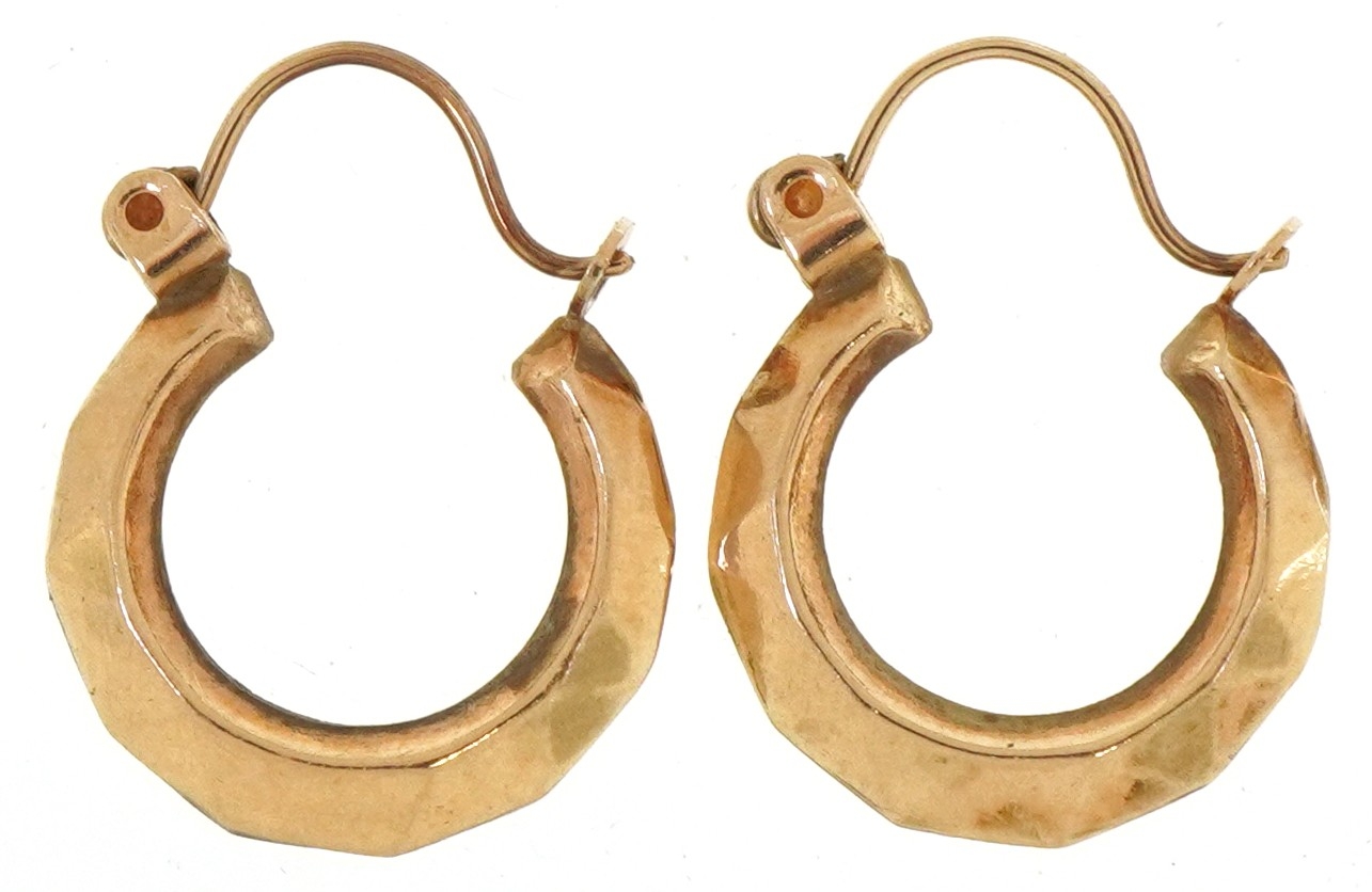 A pair of unmarked gold hoop earrings, 1.3cm in diameter, total 0.7g.