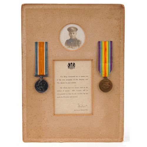 A British military World War I medal pair awarded to G-22495 PTE.C.W.WILSON THEQUEEN'SREGIMENT, mounted on card with photograph and sympathy letter.