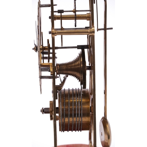 18 - A Victorian brass skeleton clock, the silvered dial having black enamelled Roman numerals, raised on... 
