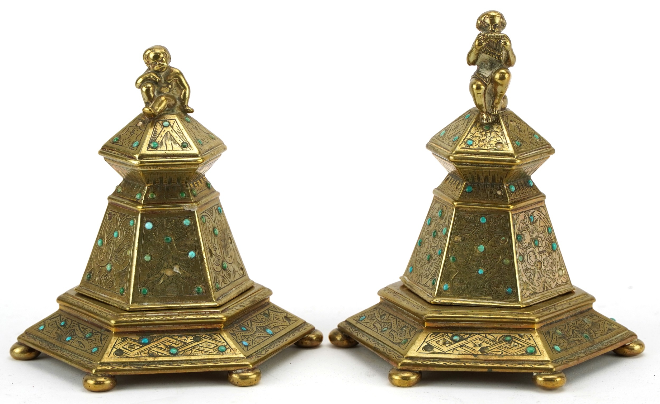 A matched pair of Victorian brass inkwells mounted with Putti and set ...
