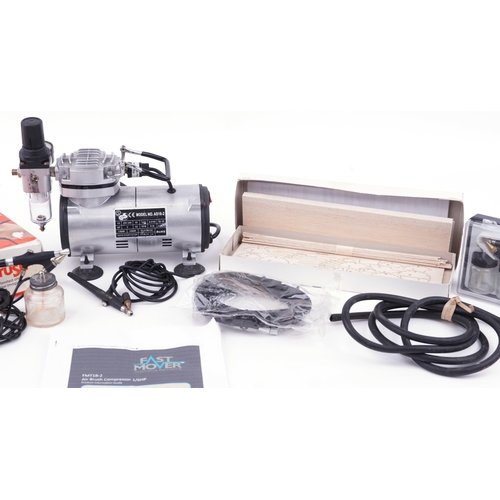 A Fast Mover model kit air compressor paint sprayer with accessories.
