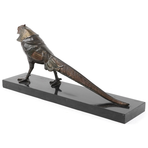 69 - An Art Deco style bronze pheasant with gilded decoration, on a black marble plinth base, 23cm high x... 