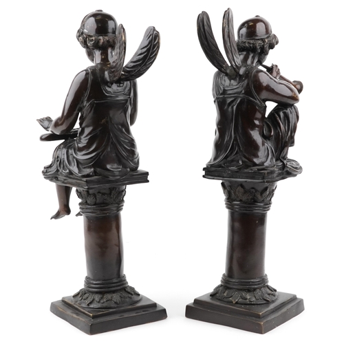 62 - After Alfred Joseph Charron - A pair of late 20th century bronze figures of fairies seated on pedest... 