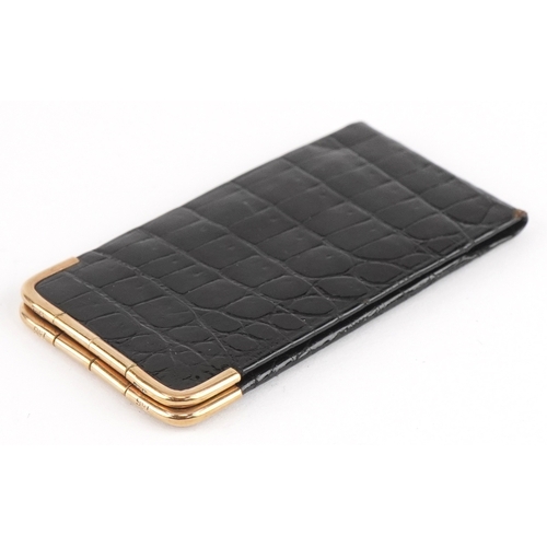 116 - A Cartier 9ct gold mounted crocodile leather etui monogrammed MG, 13cm wide open.