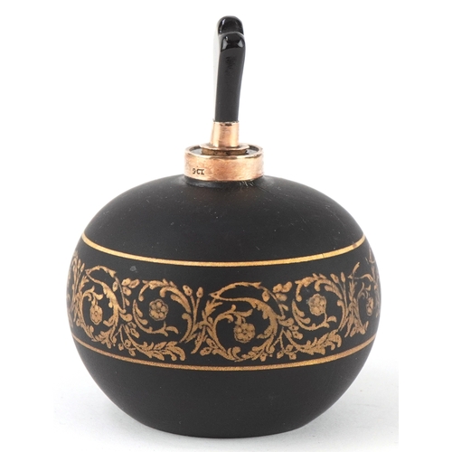 166 - A 9ct gold mounted black glass perfume bottle with gilded scrolling decoration, 7cm high.