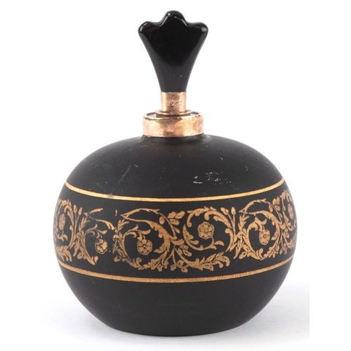 166 - A 9ct gold mounted black glass perfume bottle with gilded scrolling decoration, 7cm high.