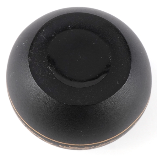 166 - A 9ct gold mounted black glass perfume bottle with gilded scrolling decoration, 7cm high.