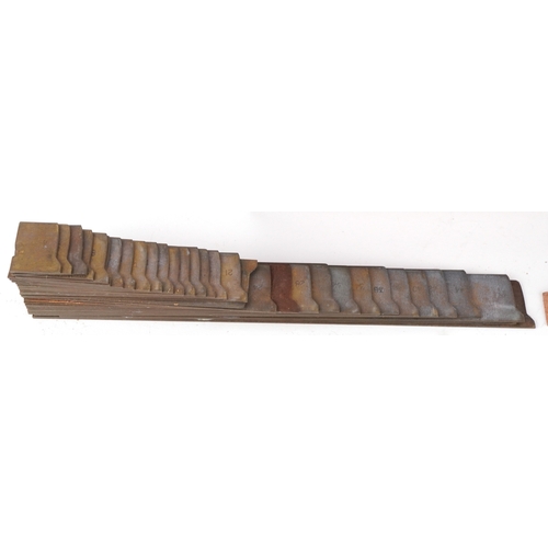 A set of brass typesetting plates, the box 24cm wide.