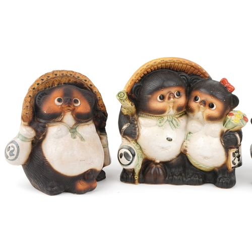 Four Japanese Tanuki pottery figures, the largest 30cm high.