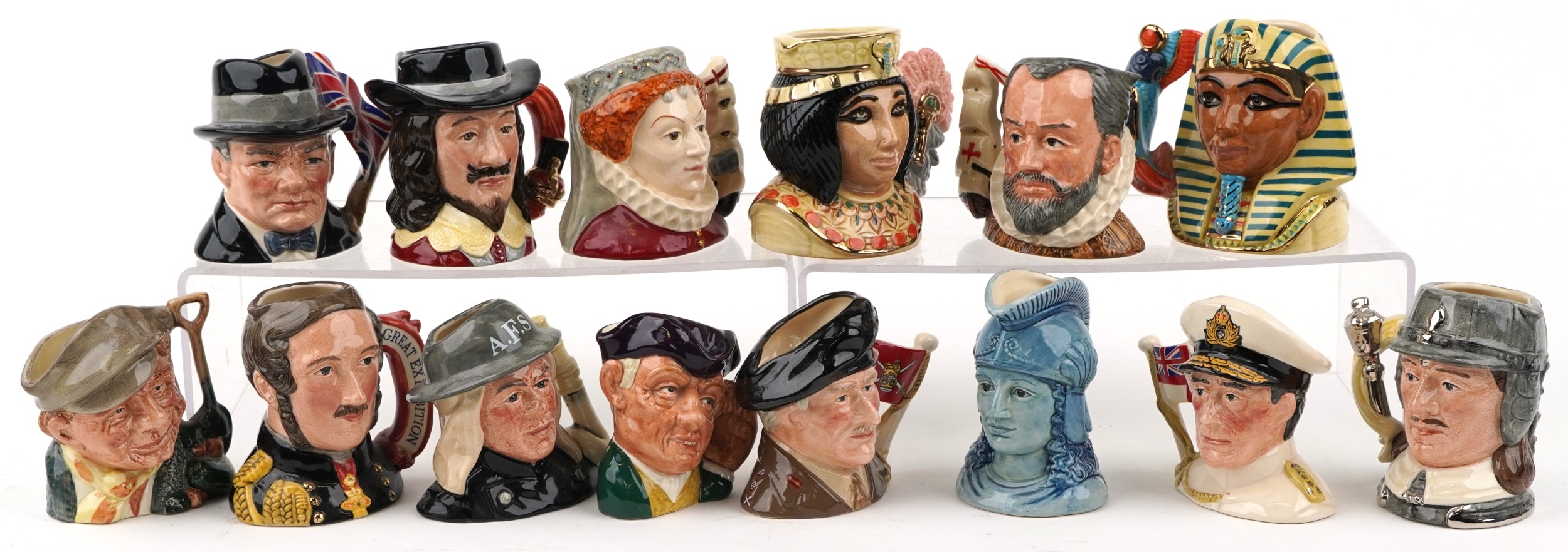A collection of Royal Doulton character jugs including Queen Elizabeth ...