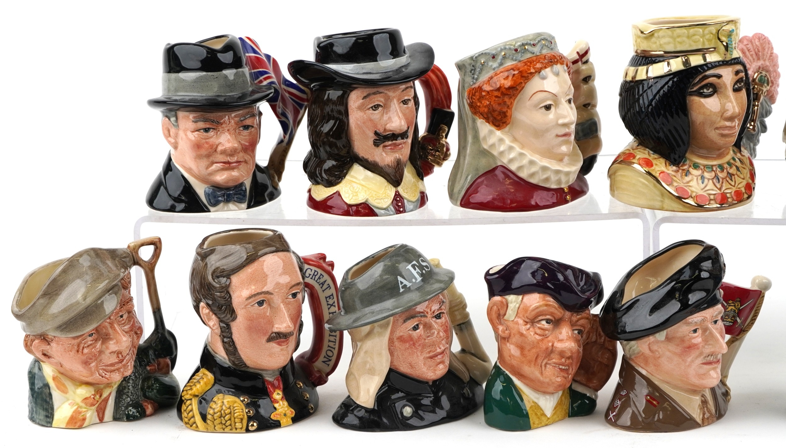 A collection of Royal Doulton character jugs including Queen Elizabeth ...