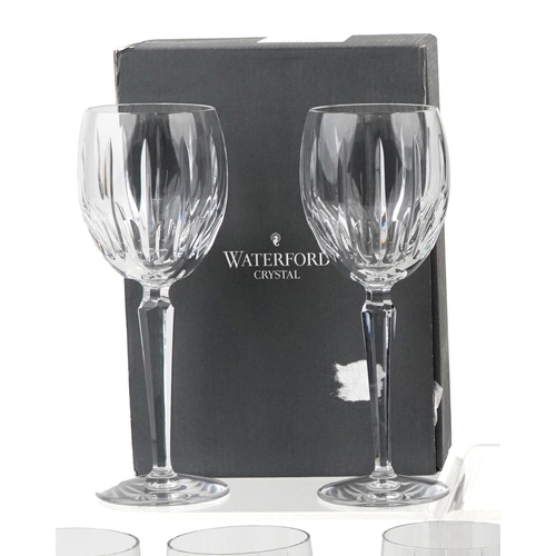 607 - A collection of Waterford Crystal glasses comprising flutes, tumblers and goblets, unused and boxed,... 