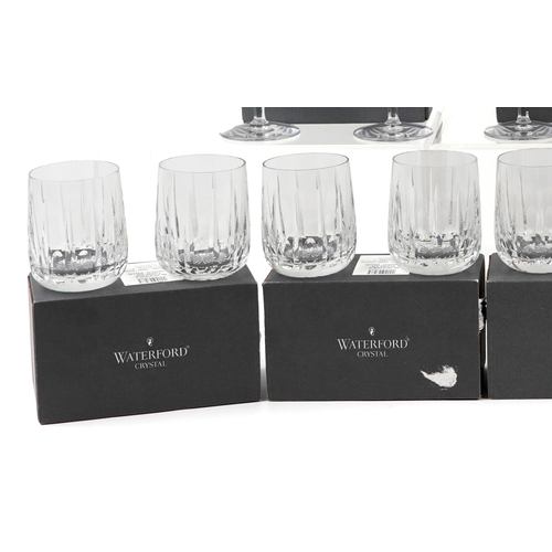 607 - A collection of Waterford Crystal glasses comprising flutes, tumblers and goblets, unused and boxed,... 