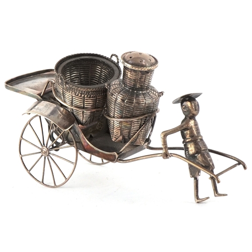 A Chinese export silver cruet set in the form of a figure pulling a rickshaw with baskets, the open salt having a glass liner, 14cm wide, total weighable silver 70.9g.