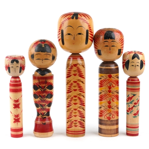 Five Japanese hand painted wooden Kokeshi dolls, the largest 45cm high.