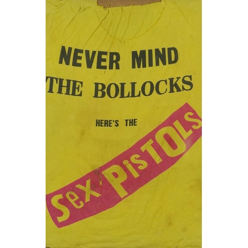 A distressed Sex Pistols Never Mind the Bollocks tee shirt, framed and glazed, 65cm x 41cm excluding the frame.