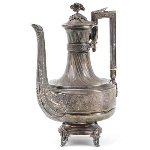 A 19th century François Nicoud silver coffee pot engraved with scrolling foliage, the hinged lid mounted with flowers, raised on four pierced feet, 21cm high, 516.0g.