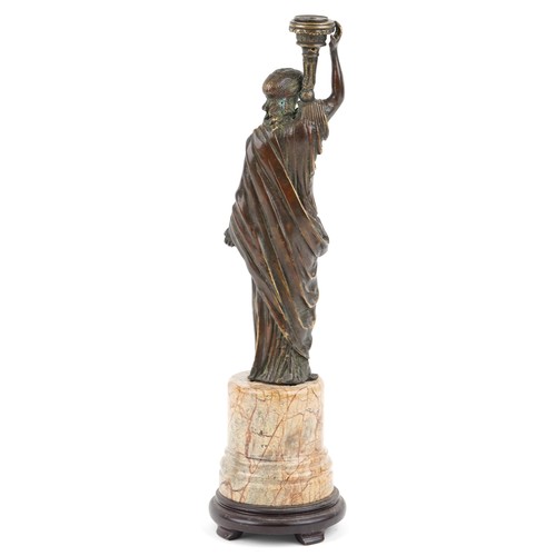 122 - A 20th century brown patinated bronze table lamp base in the form of a maiden carrying a torch, moun... 