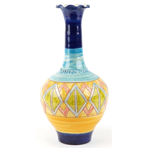 445 - A large 20th century terracotta bottleneck vase with hand painted geometric decoration, 52cm high.