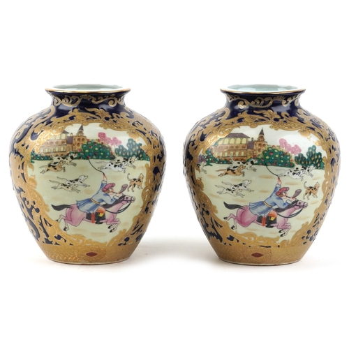 1444 - A pair of Chinese vases decorated with hunting scenes, character marks to the bases, 21cm high.