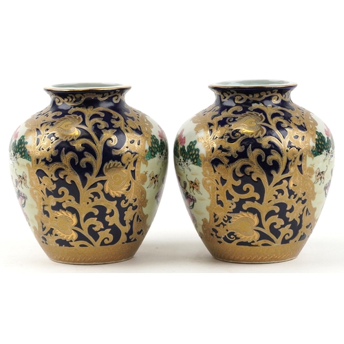 1444 - A pair of Chinese vases decorated with hunting scenes, character marks to the bases, 21cm high.