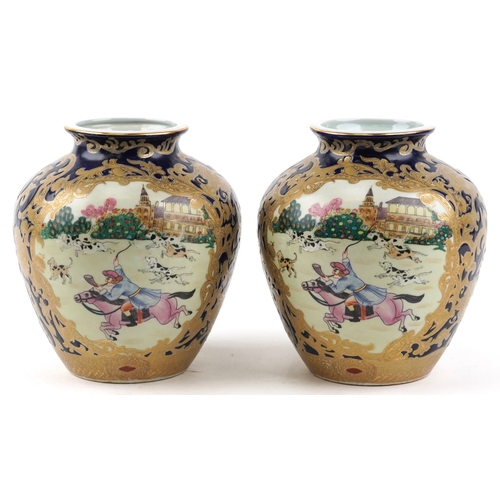 1444 - A pair of Chinese vases decorated with hunting scenes, character marks to the bases, 21cm high.