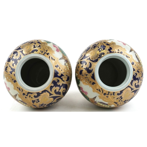 1444 - A pair of Chinese vases decorated with hunting scenes, character marks to the bases, 21cm high.