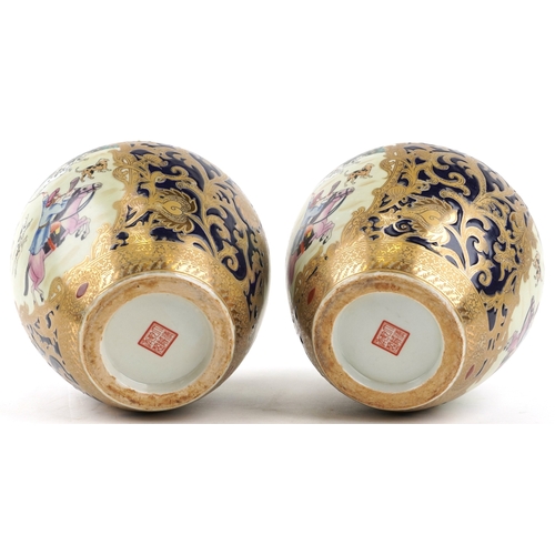 1444 - A pair of Chinese vases decorated with hunting scenes, character marks to the bases, 21cm high.