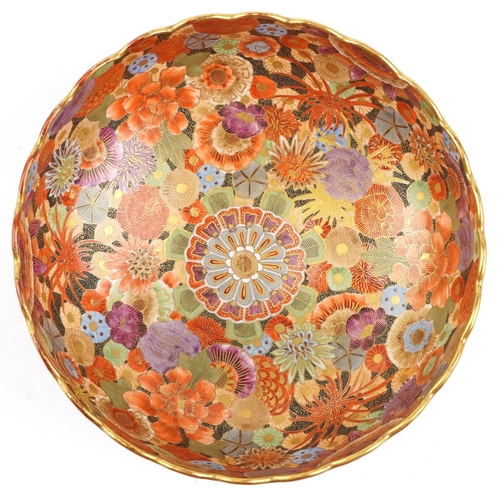  A Japanese Satsuma earthenware bowl with intricate hand painted gilded floral pattern having a scall... 