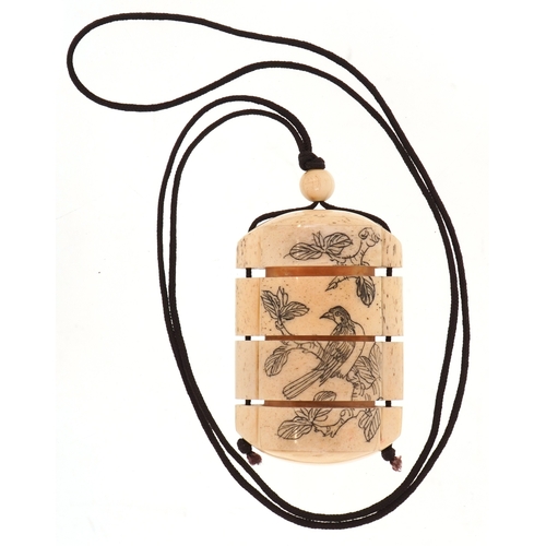 155 - A Japanese bone four section inro carved with an erotic couple and a bird, 6cm high.