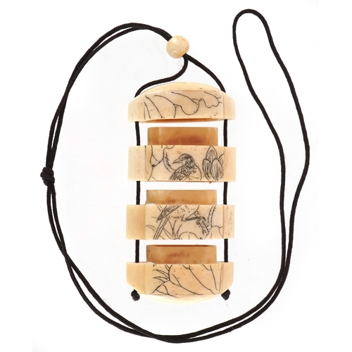 158 - A Japanese bone four section inro carved with an erotic couple and a bird, 6cm high.