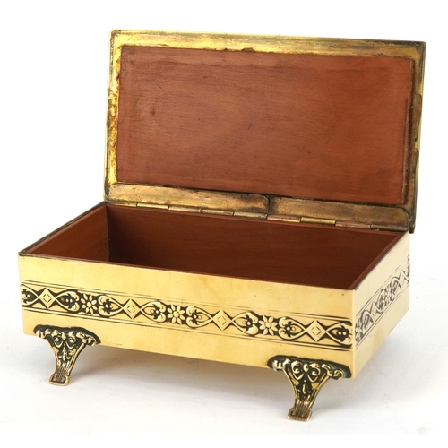  An early 20th century Lenk Austria brass and copper footed jewellery box, the hinged lid mounted wit... 