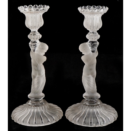 163 - Baccarat, a pair of frosted glass cherub candlesticks, 25cm high.