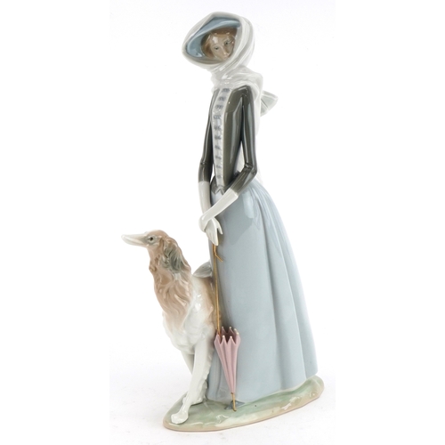 603 - A Lladro figure of a lady with Greyhound, 40cm high.