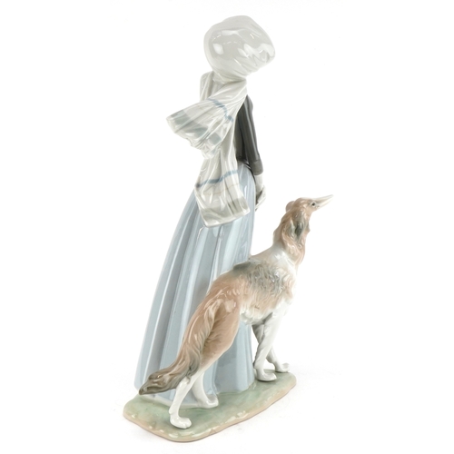 603 - A Lladro figure of a lady with Greyhound, 40cm high.