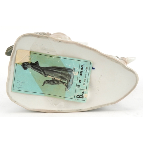 603 - A Lladro figure of a lady with Greyhound, 40cm high.