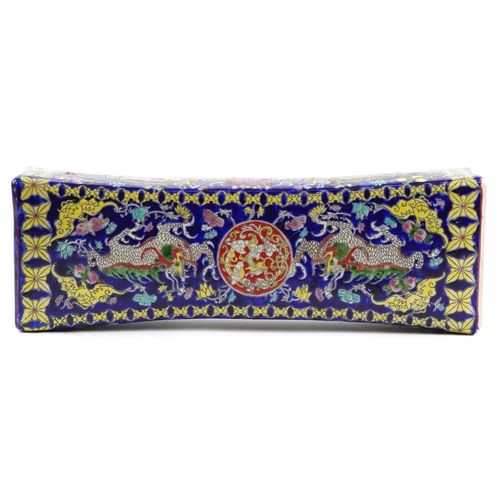 139 - A Chinese porcelain opium pillow finely hand painted with dragons and scrolling foliage, character m... 