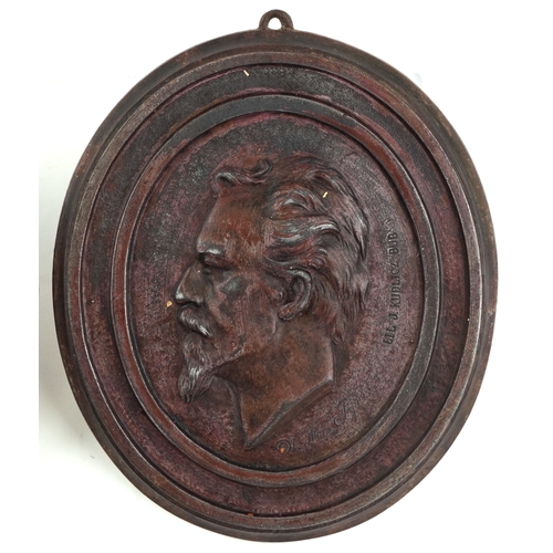 528 - Joseph Kudlicz, a pair of late 19th/early 20th century cast iron plaques of The Founders of Soilol, ... 