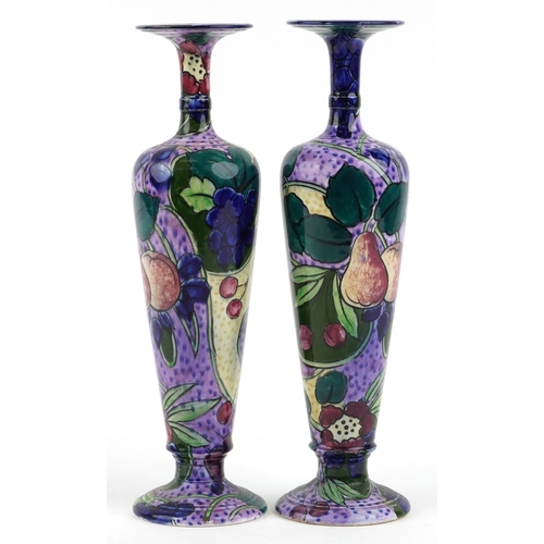 330 - A matched pair of Thomas Forrester & Sons Phoenix Ware baluster vases, each decorated with fruit, th... 