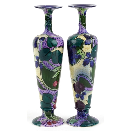 330 - A matched pair of Thomas Forrester & Sons Phoenix Ware baluster vases, each decorated with fruit, th... 