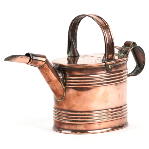 525 - An early 20th century copper watering can, 20cm high.