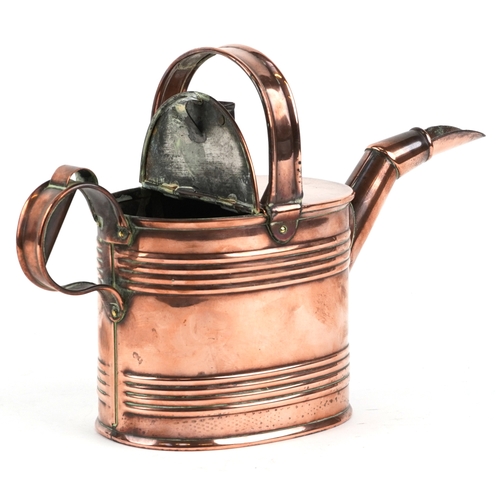 525 - An early 20th century copper watering can, 20cm high.