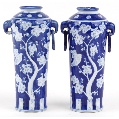 1462 - A matched pair of Chinese blue and white porcelain vases with ring handles and hand painted floral d... 