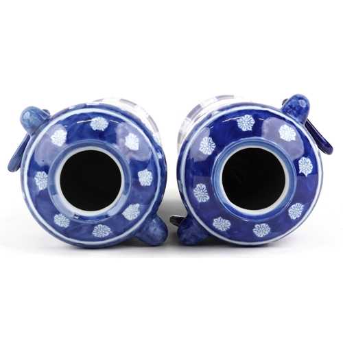 1462 - A matched pair of Chinese blue and white porcelain vases with ring handles and hand painted floral d... 