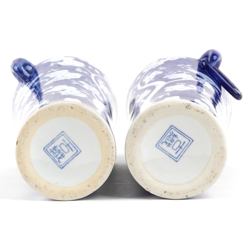 1462 - A matched pair of Chinese blue and white porcelain vases with ring handles and hand painted floral d... 