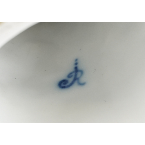 38 - A Meissen style porcelain parrot perched on a branch, under glazed R mark to the base, 27cm high.