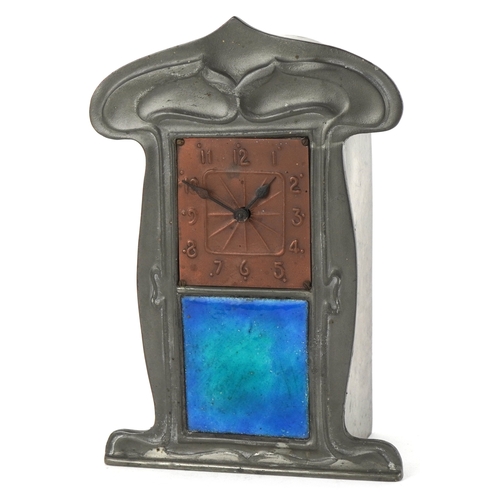  Archibald Knox for Liberty & Co., an Art Nouveau pewter tudric clock with copper dial and enamelled ... 